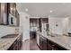 Modern kitchen features granite countertops, stainless steel appliances, dark cabinets, and hardwood floors at 3950 Grandview Manor Dr, Cumming, GA 30028