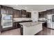 Spacious kitchen boasts stainless steel appliances, granite countertops, and dark wood cabinets at 3950 Grandview Manor Dr, Cumming, GA 30028