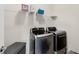 Modern laundry room with stainless steel appliances and convenient storage solutions at 3950 Grandview Manor Dr, Cumming, GA 30028