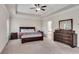 Spacious primary bedroom featuring tray ceiling, carpet and en suite bathroom at 3950 Grandview Manor Dr, Cumming, GA 30028