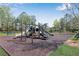 Community playground with slides, swings, and climbing structures on a rubber mulch surface at 3950 Grandview Manor Dr, Cumming, GA 30028