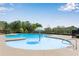 Community pool featuring a splash umbrella for surrounded by a fence and green trees at 3950 Grandview Manor Dr, Cumming, GA 30028