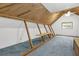 Attic space featuring wood beams and a window at 3899 Leach Rd, Snellville, GA 30039