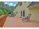 Large wooden back deck with outdoor seating offering a relaxing view of the backyard and surrounding trees at 3899 Leach Rd, Snellville, GA 30039