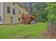 Expansive backyard featuring a wooden deck, lush lawn, and natural landscaping at 3899 Leach Rd, Snellville, GA 30039