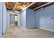 Finished basement area with light blue walls, window, and pipes on ceiling at 3899 Leach Rd, Snellville, GA 30039