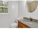 Renovated bathroom featuring a granite countertop, wood vanity, and shower with neutral tile at 3899 Leach Rd, Snellville, GA 30039