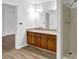 Bright bathroom with double vanity, granite countertop, tiled flooring, walk-in shower and open doorway at 3899 Leach Rd, Snellville, GA 30039