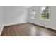 Bright bedroom with new laminate flooring and two windows at 3899 Leach Rd, Snellville, GA 30039