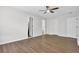 Large bright bedroom featuring laminate flooring, neutral paint and 3 doors at 3899 Leach Rd, Snellville, GA 30039