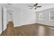Expansive bedroom with ceiling fan, laminate floors, and natural light from two windows at 3899 Leach Rd, Snellville, GA 30039