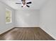 Bright bedroom featuring new laminate flooring, a ceiling fan, and a window at 3899 Leach Rd, Snellville, GA 30039