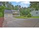 Traditional yellow home with a two-car garage and inviting front porch in a wooded setting at 3899 Leach Rd, Snellville, GA 30039