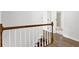 Upstairs hallway with wooden laminate flooring and view into the bathroom at 3899 Leach Rd, Snellville, GA 30039