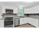 Well-lit kitchen featuring stainless appliances, granite countertops and white cabinets at 3899 Leach Rd, Snellville, GA 30039