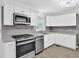 Bright kitchen with granite countertops and stainless steel appliances at 3899 Leach Rd, Snellville, GA 30039