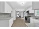Modern kitchen with gray backsplash, stainless appliances, and barn door to room at 3899 Leach Rd, Snellville, GA 30039