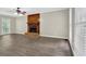 Spacious living room featuring a brick fireplace, large windows, and updated, modern flooring at 3899 Leach Rd, Snellville, GA 30039