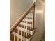 A staircase with wooden handrail and white spindles at 3899 Leach Rd, Snellville, GA 30039