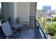 Balcony featuring chairs and a small table with city views and greenery at 711 Cosmopolitan Ne Dr # 715, Atlanta, GA 30324