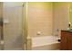 Bright bathroom featuring a walk-in shower and tub with neutral tile surround at 711 Cosmopolitan Ne Dr # 715, Atlanta, GA 30324