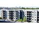 Apartment building featuring balconies, dark window frames, and trees in the foreground at 711 Cosmopolitan Ne Dr # 715, Atlanta, GA 30324