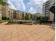 Outdoor patio and community pool area with orange umbrellas and seating with trees at 711 Cosmopolitan Ne Dr # 715, Atlanta, GA 30324