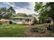 Backyard has grass and trees. Includes a deck with a wooden railing and a nice spot for a fire pit at 3207 Bobbie Ln, Decatur, GA 30032