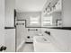 Bathroom with classic black and white tile, ample lighting, and an updated vanity at 3207 Bobbie Ln, Decatur, GA 30032