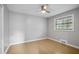 Bright bedroom featuring a ceiling fan, hardwood floors, and a window with natural light at 3207 Bobbie Ln, Decatur, GA 30032