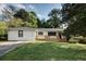 Charming single story house with a large front yard and a freshly painted white brick facade with black trim at 3207 Bobbie Ln, Decatur, GA 30032