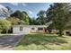 Charming single story house with a large front yard and a freshly painted white brick facade with black trim at 3207 Bobbie Ln, Decatur, GA 30032