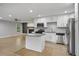 Modern kitchen with an island, stainless steel appliances, and views into the living and dining rooms at 3207 Bobbie Ln, Decatur, GA 30032
