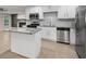 Modern kitchen featuring white cabinets, granite countertops, stainless steel appliances, and a stylish backsplash at 3207 Bobbie Ln, Decatur, GA 30032