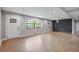 Bright open concept living room with hardwood floors, a decorative wall, and large windows with a view of the yard at 3207 Bobbie Ln, Decatur, GA 30032