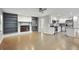 Bright living room with hardwood floors, fireplace and built-in shelving, flowing into the updated kitchen at 3207 Bobbie Ln, Decatur, GA 30032