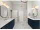Bright bathroom featuring double vanities, stylish mirrors, and white marble floors for a spa-like experience at 3295 Millwood Se Trl, Smyrna, GA 30080