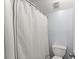 Cozy bathroom featuring a shower curtain, toilet, and neutral colors creating a functional and private space at 3295 Millwood Se Trl, Smyrna, GA 30080