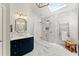 Bathroom with a large glass shower, skylight, and a blue vanity at 3295 Millwood Se Trl, Smyrna, GA 30080