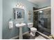 Well-lit bathroom features a stylish pedestal sink and glass-enclosed shower with decorative tiling at 3295 Millwood Se Trl, Smyrna, GA 30080