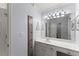 Well-lit bathroom with a white vanity, framed mirror, and soft blue walls creating a clean and refreshing space at 3295 Millwood Se Trl, Smyrna, GA 30080