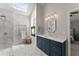 Luxurious bathroom featuring marble tile, walk-in shower, sleek vanity, and a heated towel rack for added comfort at 3295 Millwood Se Trl, Smyrna, GA 30080