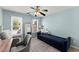 Bedroom painted blue with natural light, ceiling fan, and a convertible daybed at 3295 Millwood Se Trl, Smyrna, GA 30080