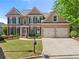 Charming brick home featuring a well-manicured lawn and a two-car garage at 3295 Millwood Se Trl, Smyrna, GA 30080
