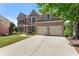 Beautiful brick home showcasing a well-kept lawn and attached two-car garage at 3295 Millwood Se Trl, Smyrna, GA 30080