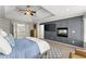 Main bedroom with paneled accent wall, view of hallway, ceiling fan and tray ceiling at 3295 Millwood Se Trl, Smyrna, GA 30080