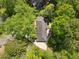 Aerial view of a home surrounded by mature trees and a long driveway at 3982 Battleford Ct, Atlanta, GA 30341
