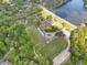 An aerial view showcasing multiple baseball and soccer fields next to a shimmering lake surrounded by lush greenery at 3982 Battleford Ct, Atlanta, GA 30341