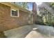 Backyard featuring a concrete patio, brick exterior, and a view of the lawn and surrounding trees at 3982 Battleford Ct, Atlanta, GA 30341