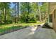 Backyard featuring a concrete patio, black metal railing, and a large lawn at 3982 Battleford Ct, Atlanta, GA 30341